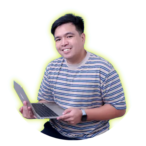 Mark Kevin Rigor, smiling, holding an open laptop.